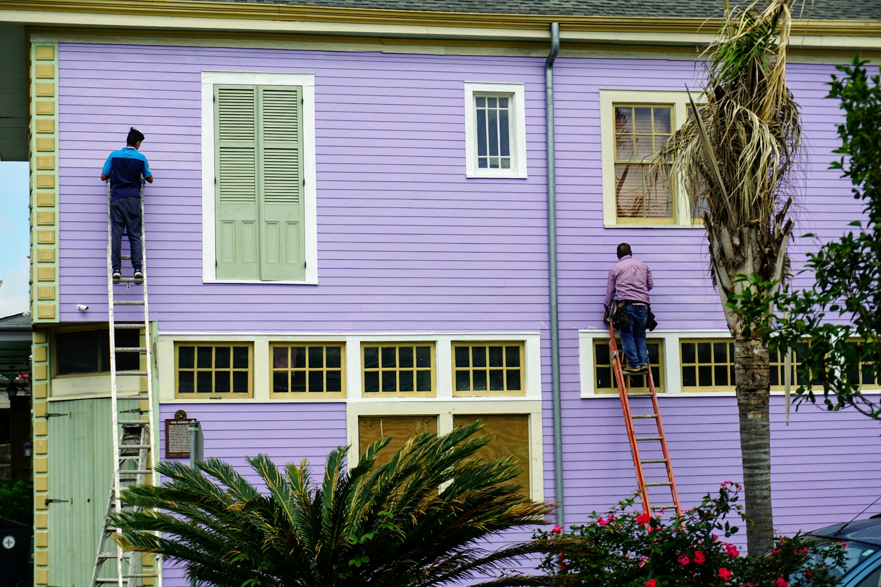 Painters working carefully across a large character-home exterior